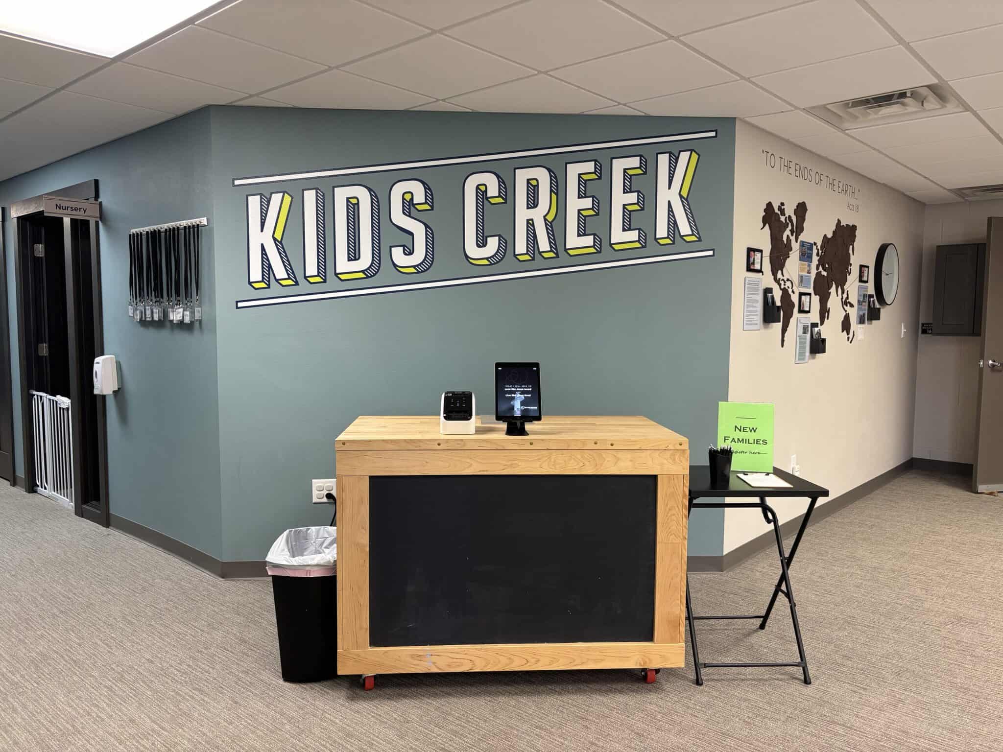 The Kids Creek check-in station and sign in the Riverwood Church lobby