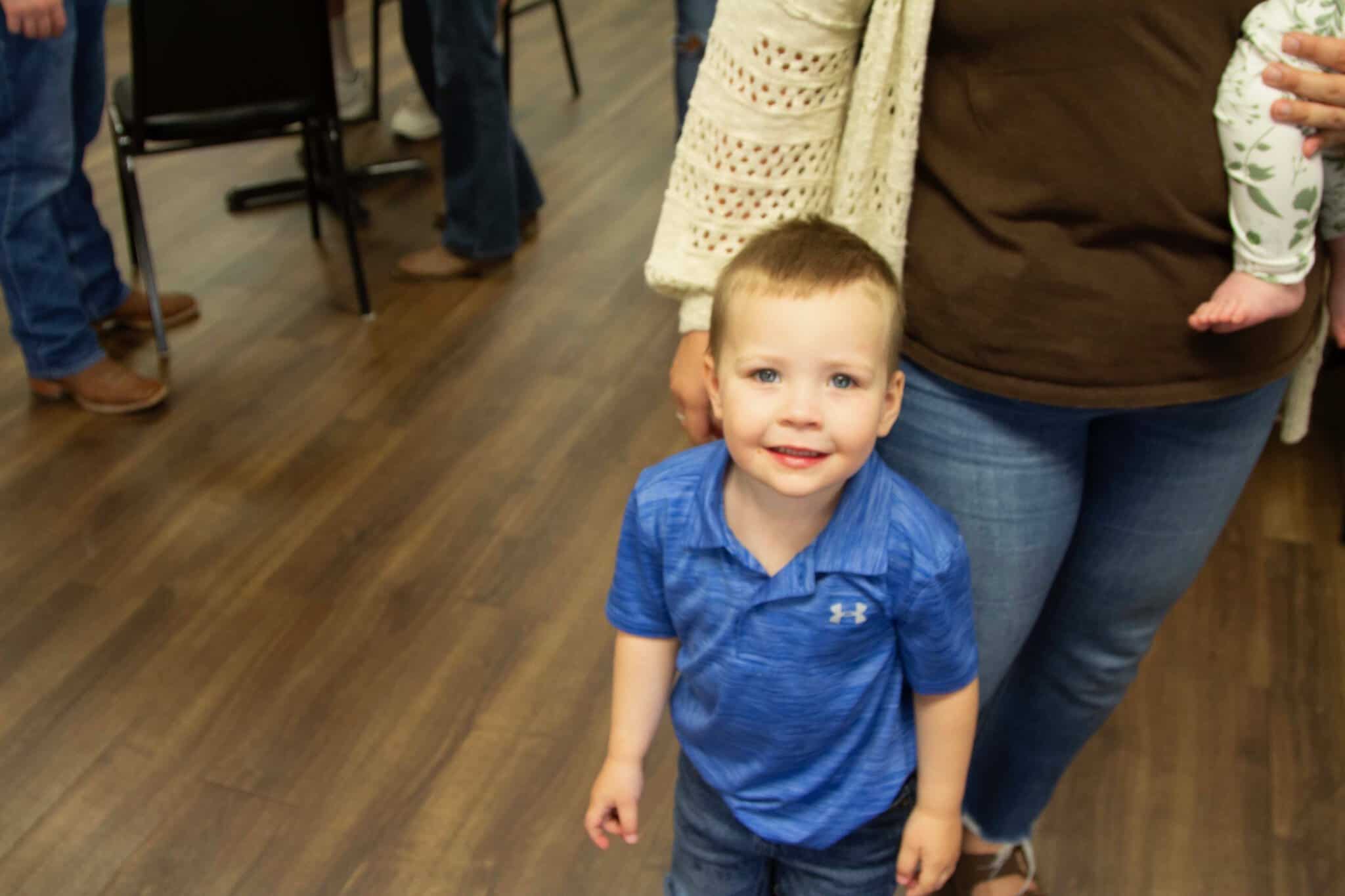 A young boy smiling in the lobby before Kids Creek at Riverwood Church